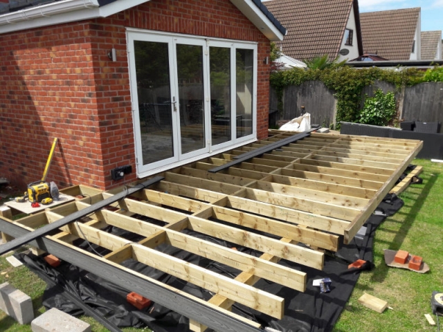 Composite deck with outside lights being built by Four Seasons Roof Systems